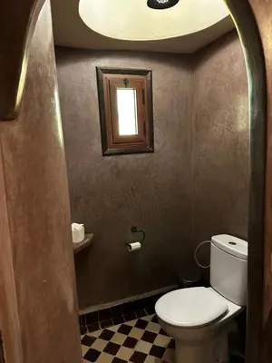 a small bathroom with a toilet and a window at Dar Hassan Merzouga in Merzouga