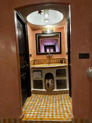 a bathroom with a sink and a mirror at Dar Hassan Merzouga in Merzouga