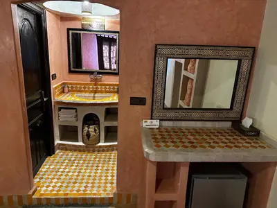 a bathroom with a sink and a mirror at Dar Hassan Merzouga in Merzouga