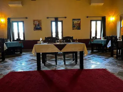 a dining room with a table in the middle at Dar Hassan Merzouga in Merzouga