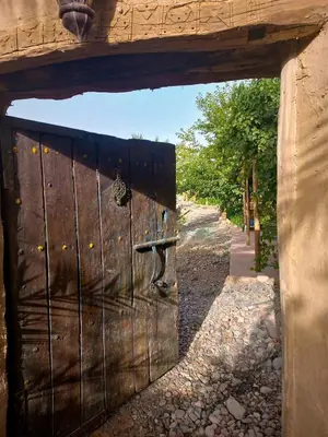 an entrance to a wooden door in a building at RIAD AMAN SKOURA in Skoura