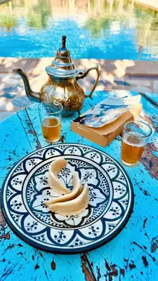 a plate of bananas on a table with a tea kettle at RIAD AMAN SKOURA in Skoura
