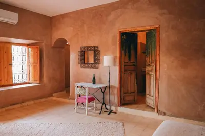 a room with a table and a window and a door at RIAD AMAN SKOURA in Skoura