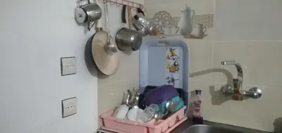 a kitchen sink with a pink rack next to a sink at DAR RACHIDA in Aït Taoujdate