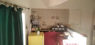 a kitchen with a stove and a yellow refrigerator at DAR RACHIDA in Aït Taoujdate