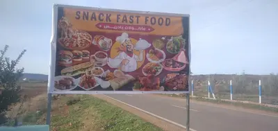 a sign on the side of a road at DAR RACHIDA in Aït Taoujdate