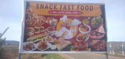 a sign for a snack fast food on the side of a road at DAR RACHIDA in Aït Taoujdate