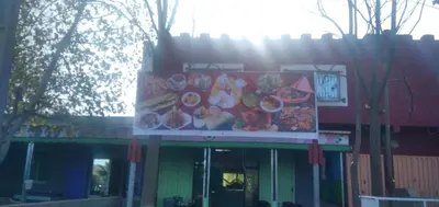 a sign in front of a fast food restaurant at DAR RACHIDA in Aït Taoujdate