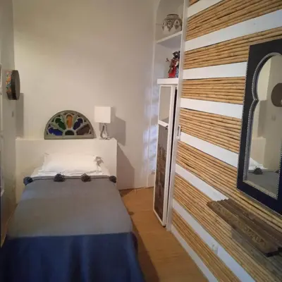 a bedroom with a bed and a wooden wall at DAR ORANGE in Fès