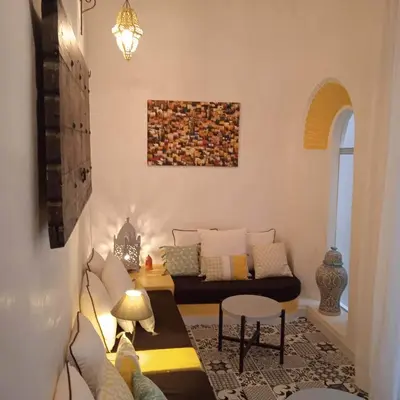 a living room with a couch and a table at DAR ORANGE in Fès