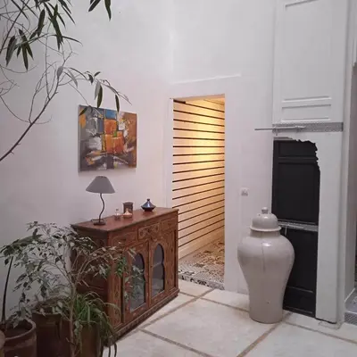 a living room with a wooden table and a table sidx sidx sidx at DAR ORANGE in Fès