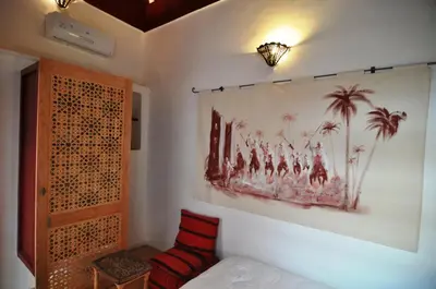 a room with a wall with a painting on the wall at DAR ORANGE in Fès