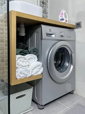 a washer and dryer on a shelf with towels at Chez Siham in Fès