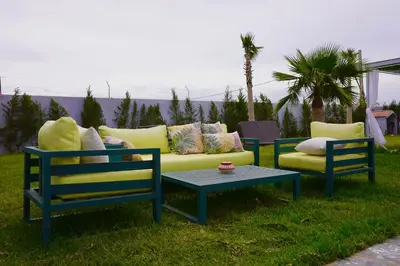 two chairs and a couch and a coffee table at Villa moderne Marrakech in Marrakech