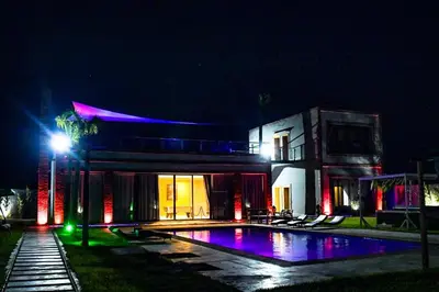 a house with a swimming pool at night at Villa moderne Marrakech in Marrakech