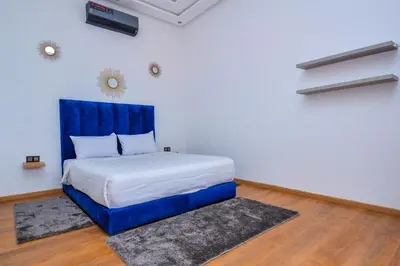 a bed with a blue headboard in a room at Villa moderne Marrakech in Marrakech
