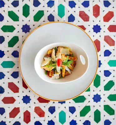 a white bowl of food on a table at RIAD GOLD in Azrou