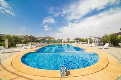 a pool at a resort with chairs at RIAD GOLD in Azrou