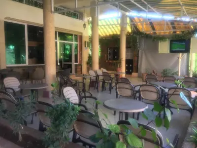 a group of tables and chairs in a restaurant at Ighbola Ouzoud in Ouzoud