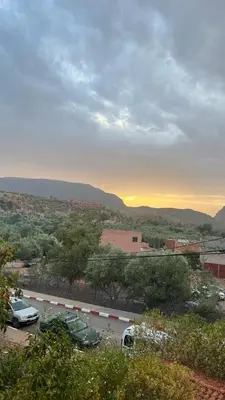 a view of a city with cars parked in a parking lot at Ighbola Ouzoud in Ouzoud