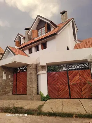 a house with two garage doors at Villa jouhara in Ifrane