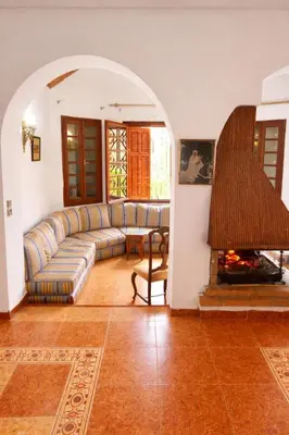 a living room with a couch and a fireplace at Villa jouhara in Ifrane