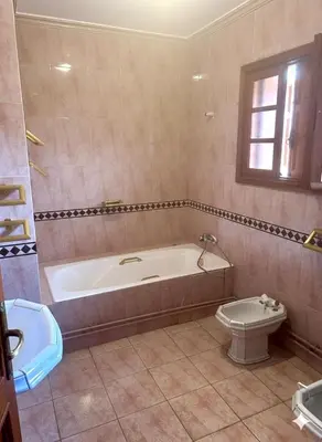 a bathroom with a tub and a toilet at Villa jouhara in Ifrane