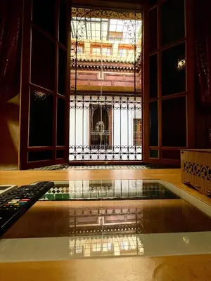 a room with a swimming pool and a window at Riad Dar Lalj Fes in Fès