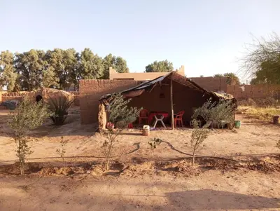 a small house in the middle of a desert at La Maison-Berbère Mhamid in Mhamid