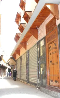 a building with metal doors on the side of a street at Maison Moussaoui in Meknès