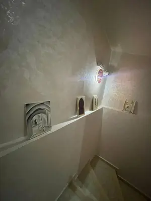a bathroom with a staircase with a fire place at Maison Moussaoui in Meknès