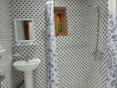 a bathroom with a sink and a shower at Maison Moussaoui in Meknès