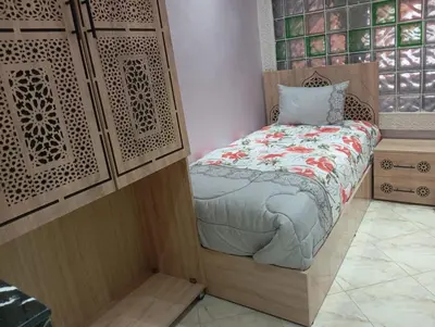 a small bedroom with a bed in a room at Maison Moussaoui in Meknès