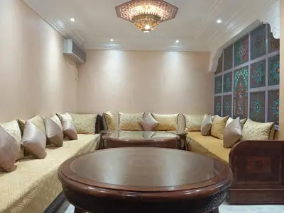 a living room with a couch and a table at Maison Moussaoui in Meknès