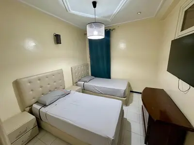a hospital room with two beds and a table at Jawhara Jacobs apartment in Fès