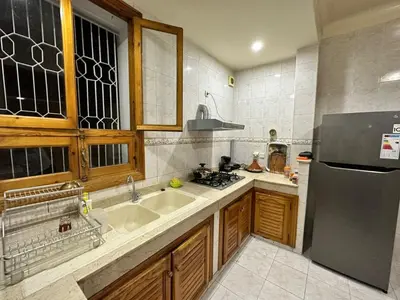 a kitchen with a sink and a refrigerator at Jawhara Jacobs apartment in Fès