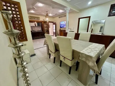 a dining room with a table and chairs at Jawhara Jacobs apartment in Fès