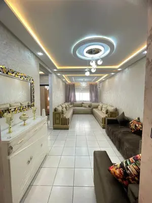 a living room with a couch and a mirror at Oued fes hay molay driss in Fès