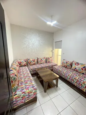 a living room with a couch and a coffee table at Oued fes hay molay driss in Fès