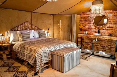a bedroom with a large bed in a tent at Sky View Camp in Merzouga
