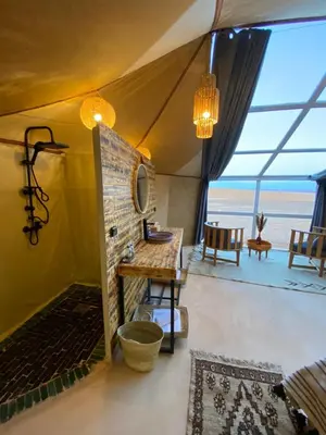 a room with a sink and a table in a tent at Sky View Camp in Merzouga