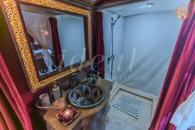 a bathroom with a sink and a mirror at ideal desert camp in Merzouga