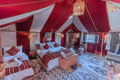 a bedroom with two beds in a tent at ideal desert camp in Merzouga
