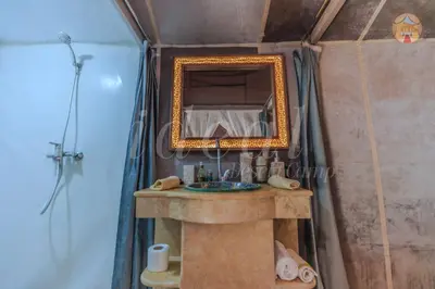 a bathroom with a sink and a mirror at ideal desert camp in Merzouga