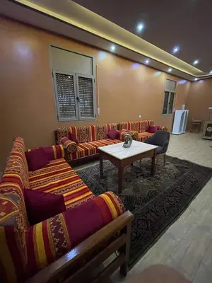 a living room with couches and a table in a room at Palm Garden in Erfoud