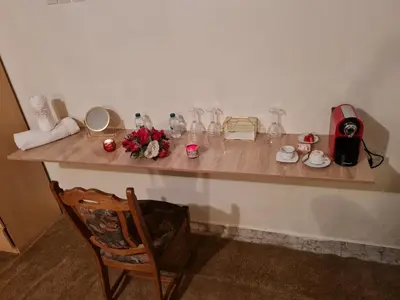 a counter with vases and flowers on top of it at Hôtel et Restaurant ARIJ in Midelt