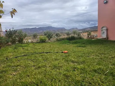 a hose laying in the grass in a yard at Ferme Jnan Al Yassmine in Taza