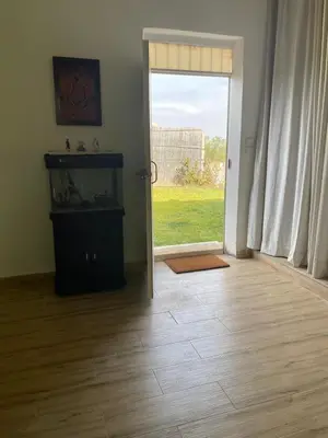 a living room with a door open to a yard at Ferme Jnan Al Yassmine in Taza
