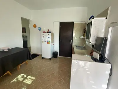 a kitchen with a refrigerator and a table in it at Ferme Jnan Al Yassmine in Taza