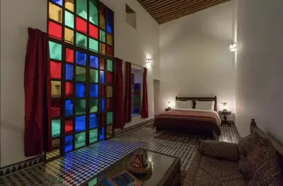 a room with a colorful stained glass window at Riad Alfredo in Fès